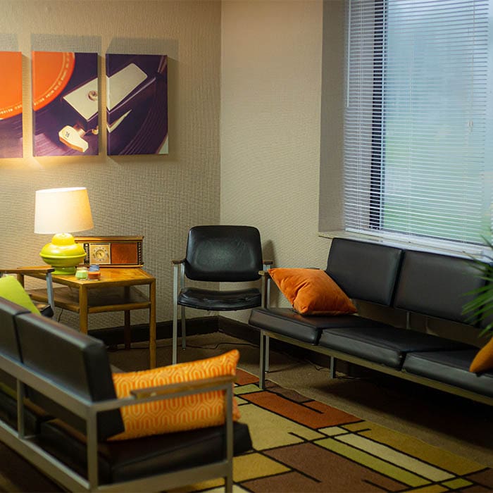 0L8A9976 WHFB waiting area with black leather couch and chairs